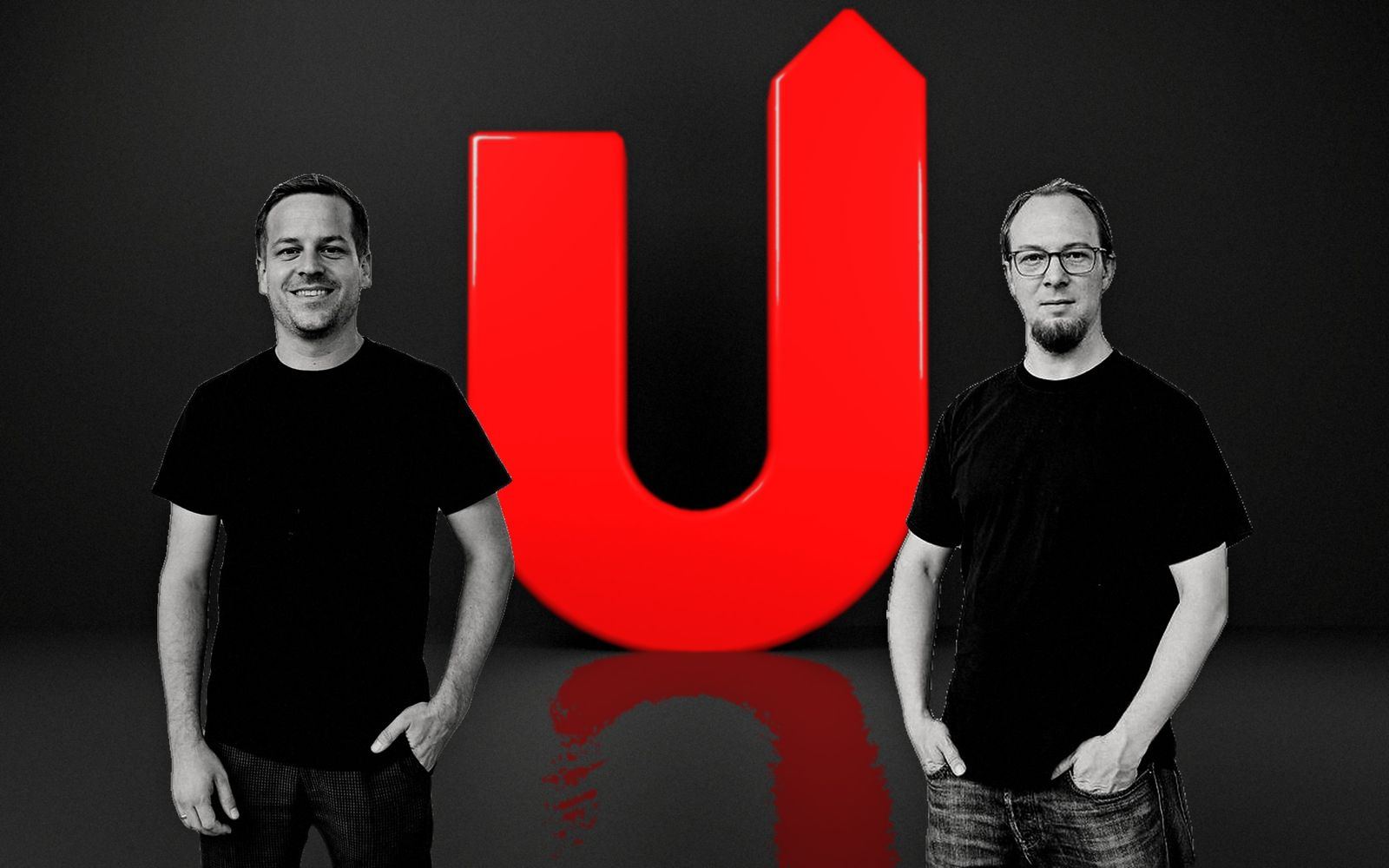 Dominik Gerber und Nicolas Weiß neben einem großen roten U im dunklen Studio